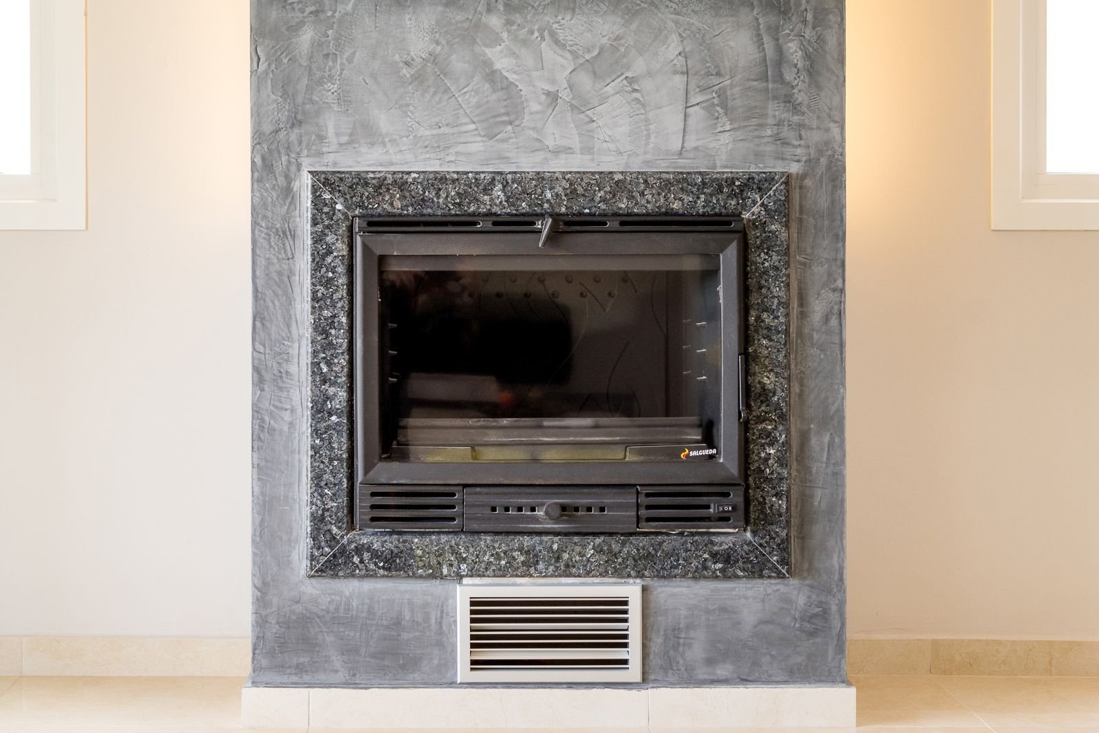 Energy-efficient wood-burning fireplace in the lounge of Villa Pisti, Castelia, Corfu